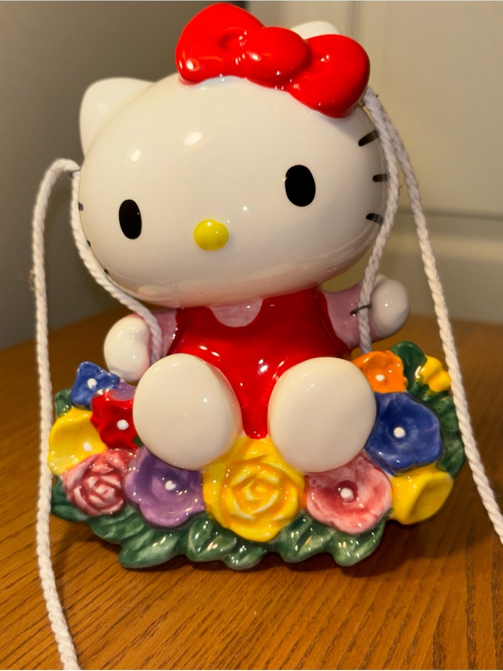 Sanrio Hello Kitty Red Bow and Dress Figurine with Multicolor Floral Base